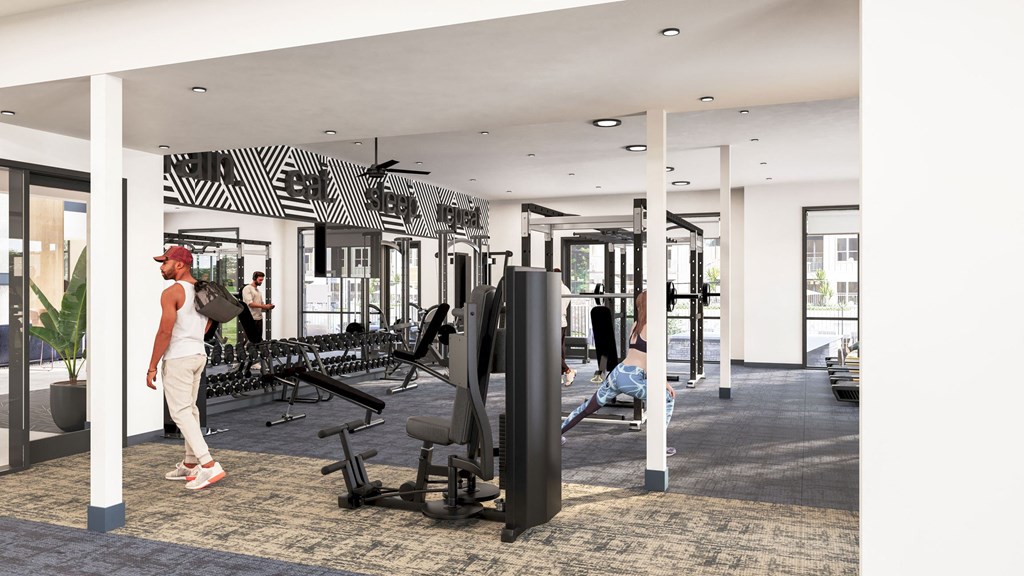a woman walking in a gym with weights and other exercise equipment