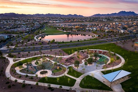 an aerial view of the skate park at sunset with the city in the background