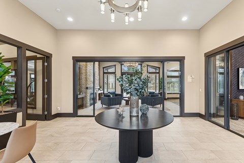 A modern dining room with a round table and chairs.