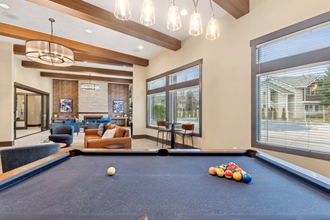 A pool table with a white ball and some colorful balls on it.
