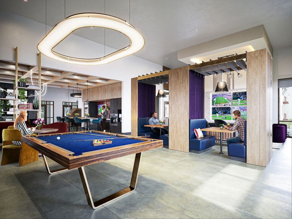 a pool table in a lobby with people sitting at tables