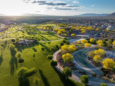 an aerial view of a park with the city in the background