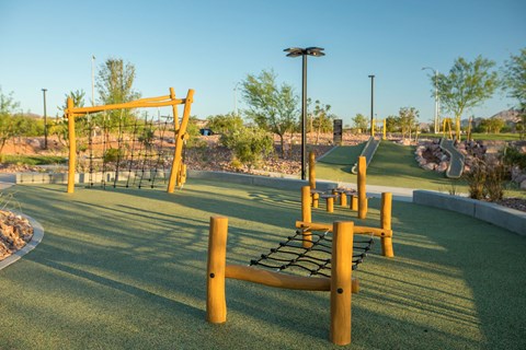 a playground with a swing set in a park