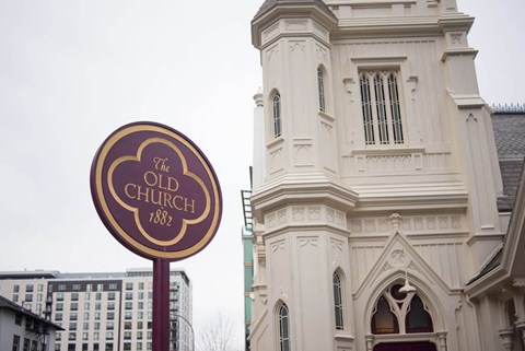 the old church sign in front of a building