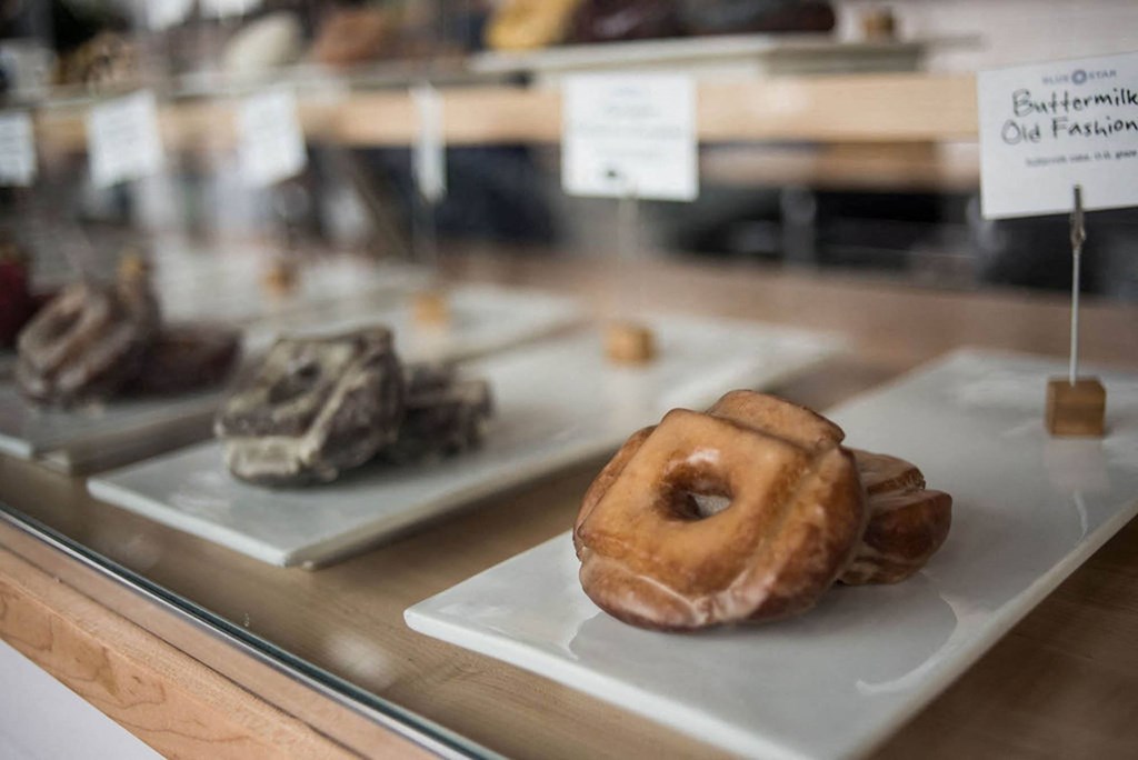 a display case filled with different types of donuts and other desserts
