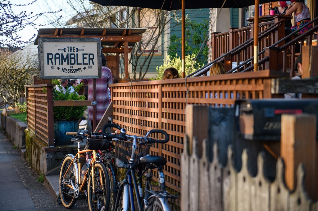 a row of bikes parked in front of a brick fence