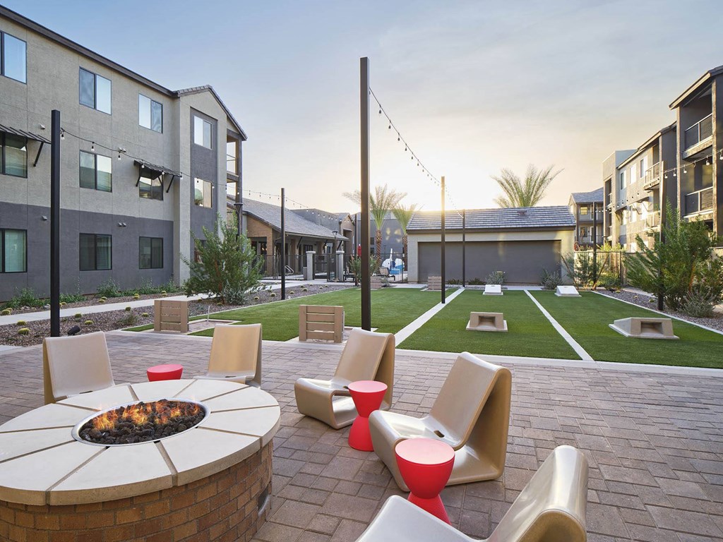 an outdoor patio with chairs and a fire pit