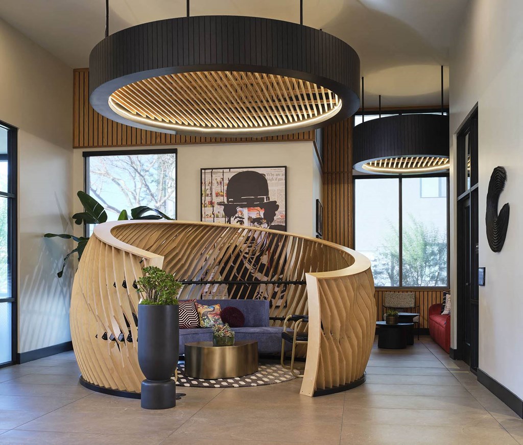 the lobby or reception area of a hotel with a wooden reception desk