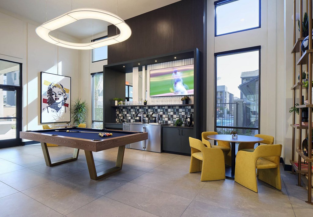 a game room with a pool table and a television