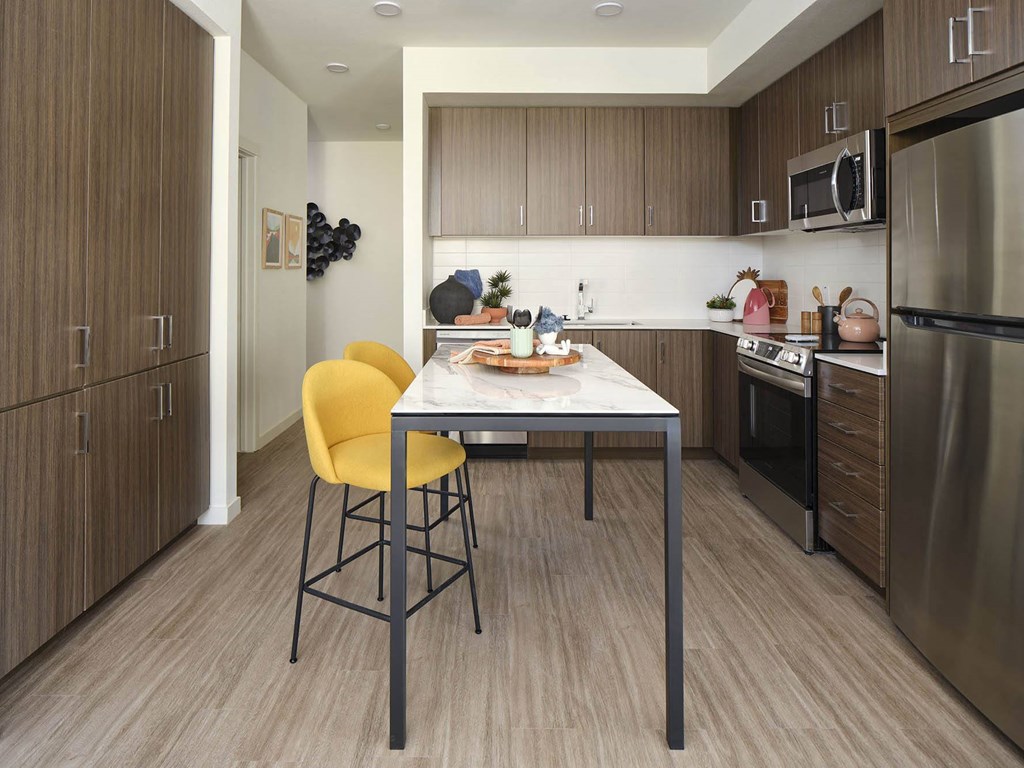 a kitchen with a table and chairs