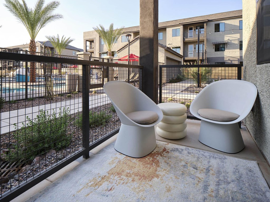 two toilets sitting on a balcony next to a fence