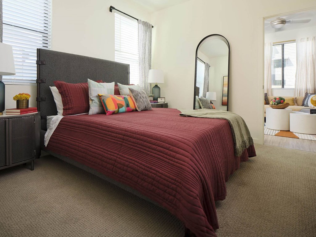 a bedroom with a bed and a mirror