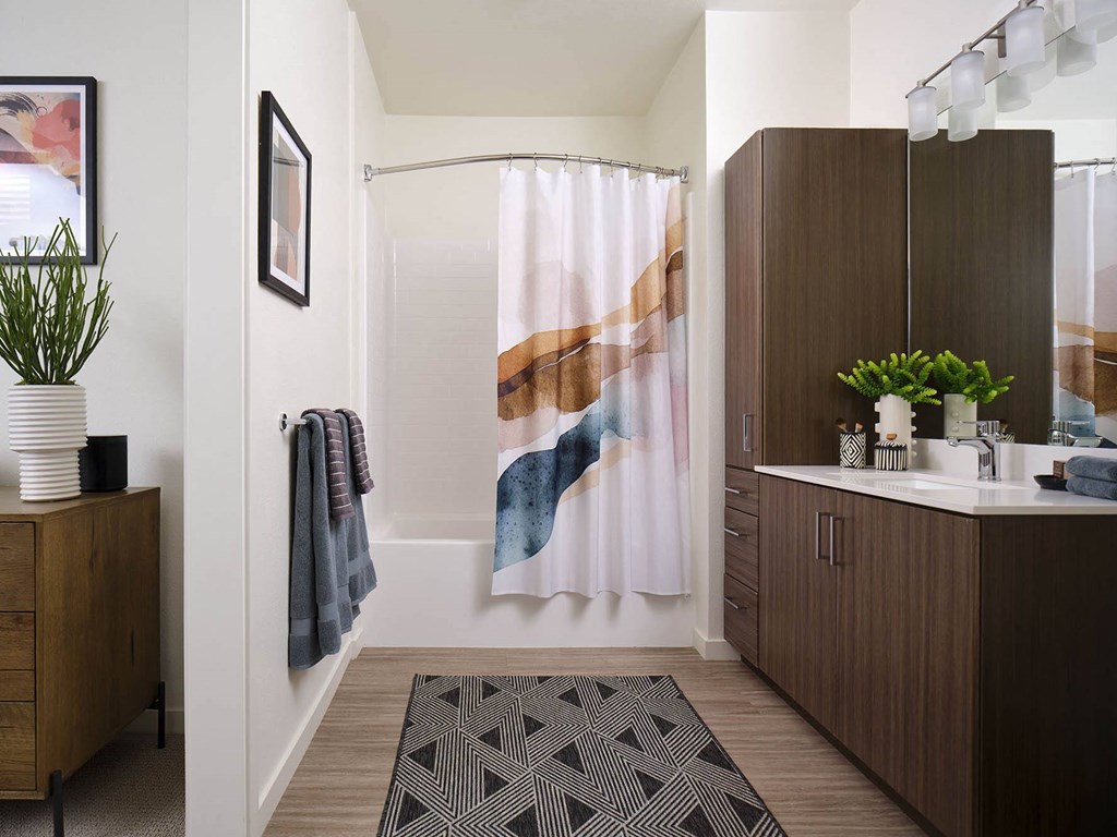 a bathroom with a shower and a sink in it