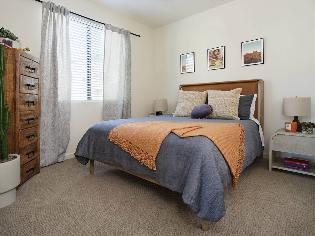 a bedroom with a bed and a dresser