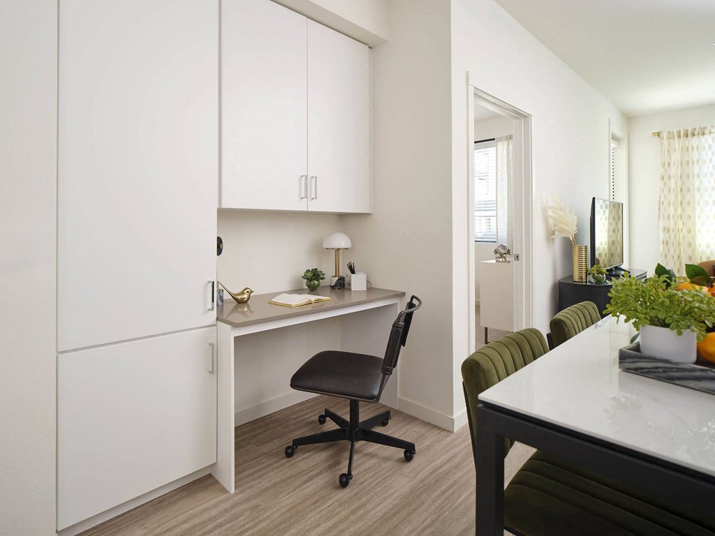 a kitchen or kitchenette with a desk and a chair