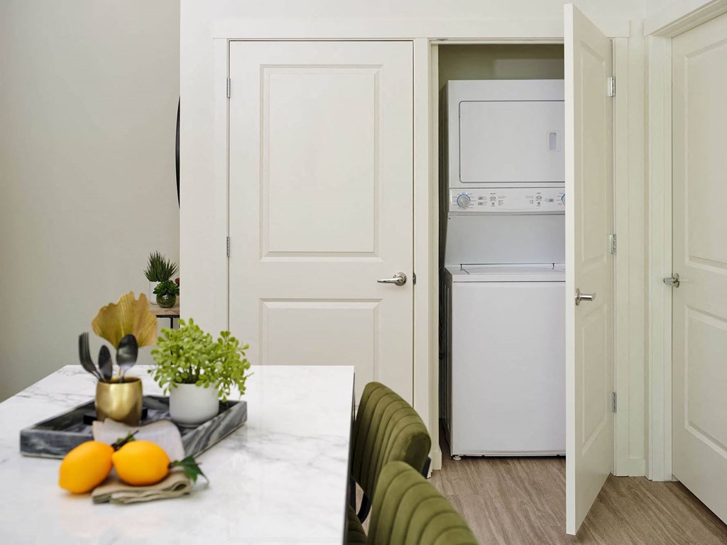 a kitchen and dining room with white appliances and a table