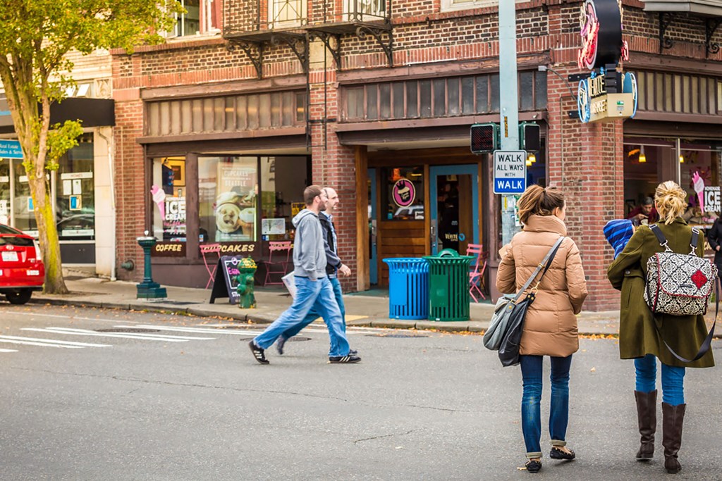 Group of People Walking in Downtown West Seattle Intersection