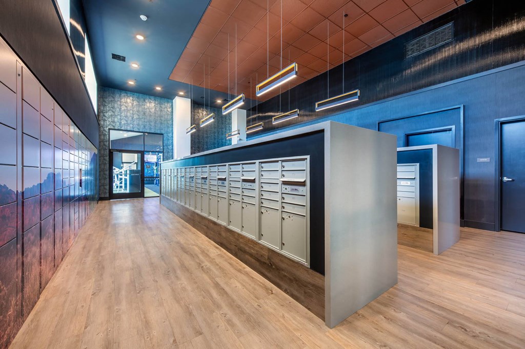 the lobby of a building with a long row of mailboxes
