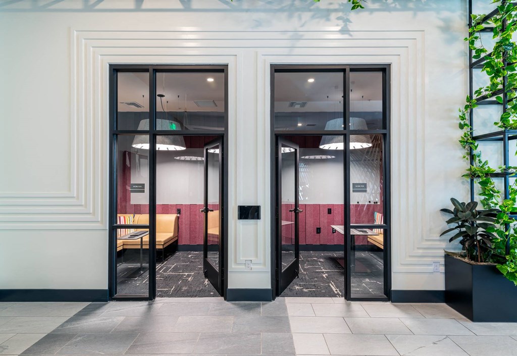 a view of the entrance to a restaurant through glass doors