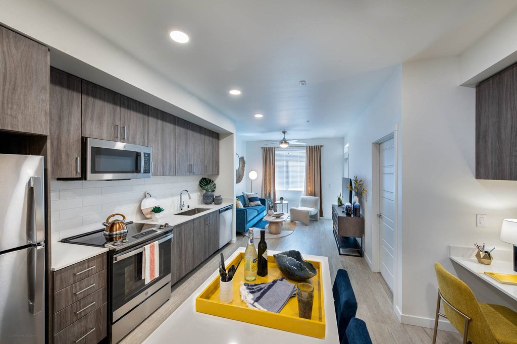 a kitchen and living room with a yellow table
