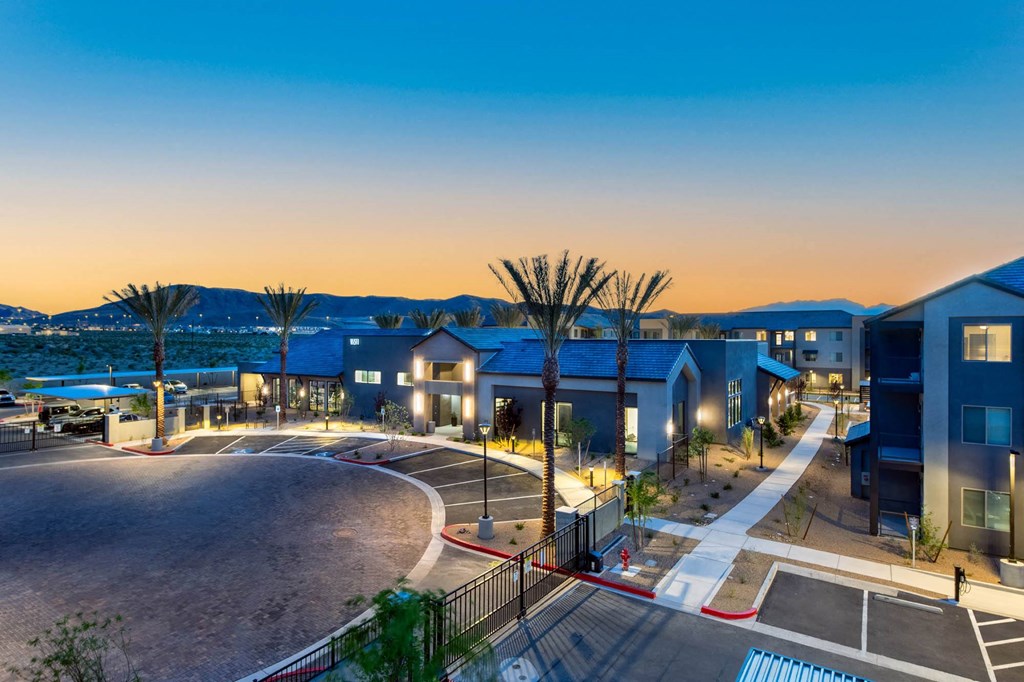 a building with a swimming pool at dusk