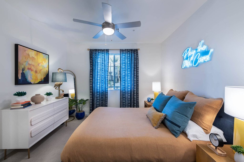 a bedroom with a large bed and a ceiling fan
