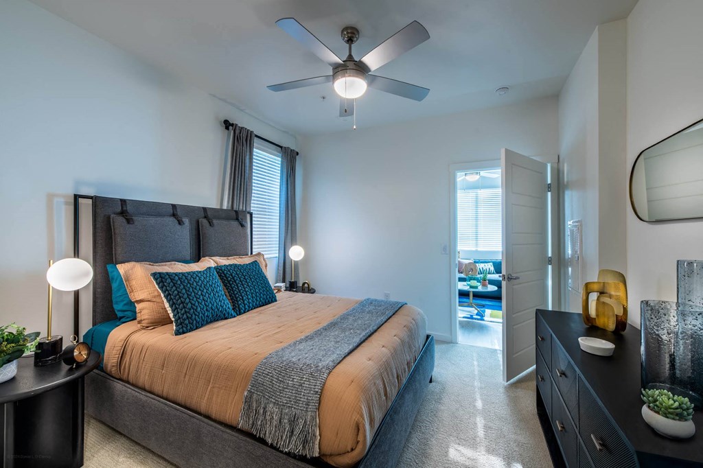 a bedroom with a bed and a ceiling fan