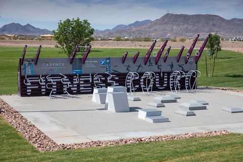 a sculpture of baseball bats on display in a park