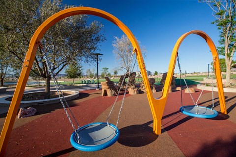 a swing set on a playground at a park
