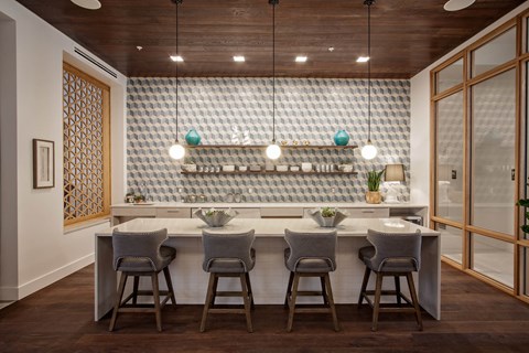 a kitchen with a marble counter top and bar stools