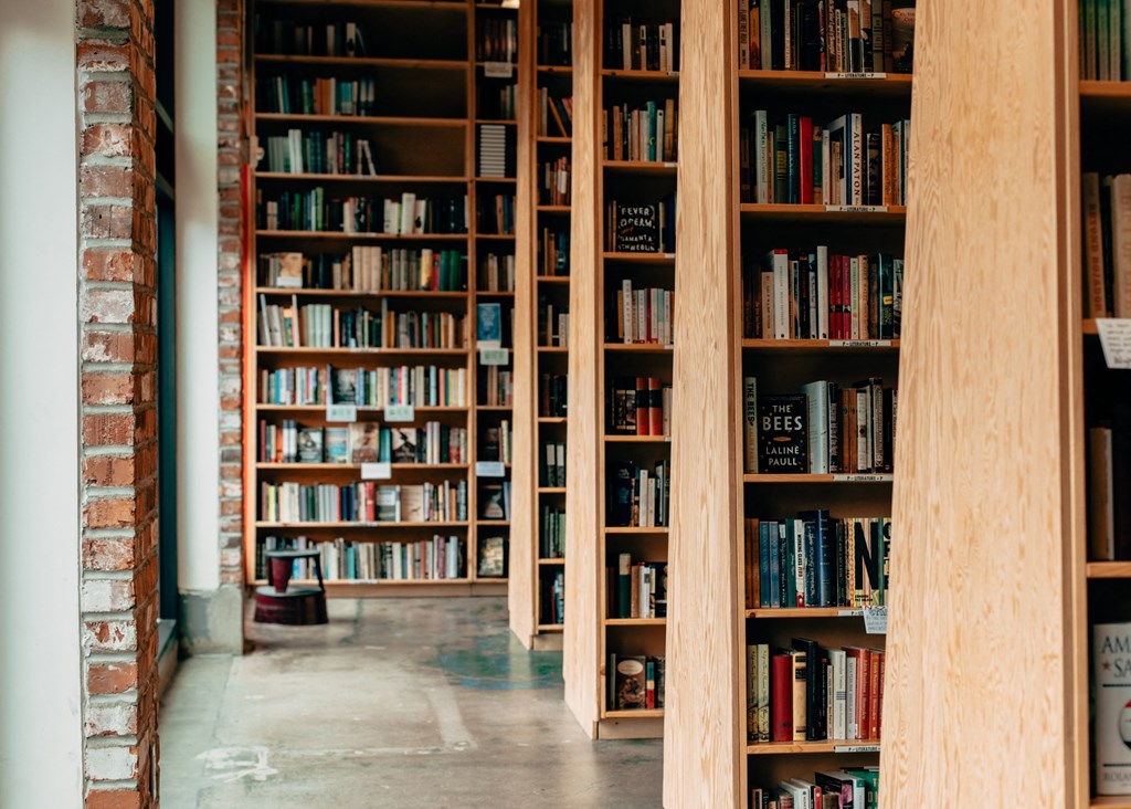 a library with wooden shelves filled with books