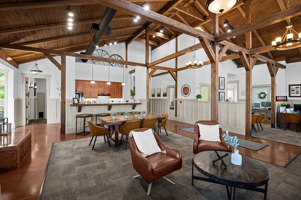 a living room with a table and chairs and a kitchen