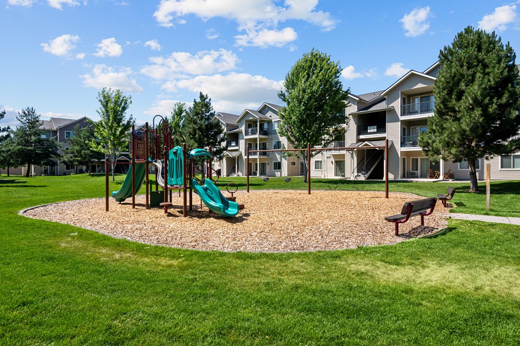 the preserve at ballantyne commons playground with play equipment and apartments in the background