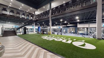 the gym has a lawn with a large white logo on it