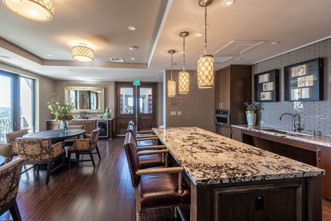 a large kitchen with a marble counter top