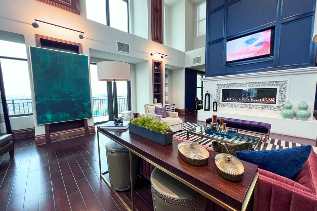a living room with a long wooden table and a fireplace