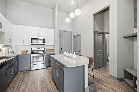 A modern kitchen with a stove top oven and a microwave.