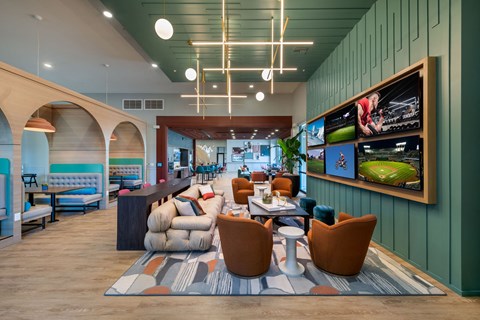 the lobby of a hotel with couches and tables and chairs