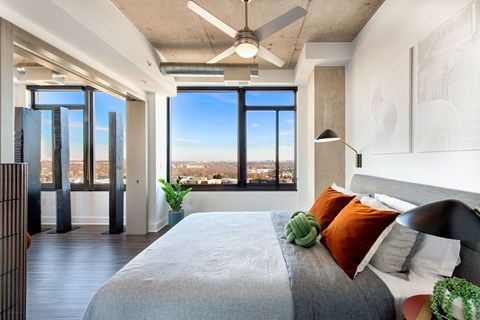a bedroom with a large bed and a ceiling fan