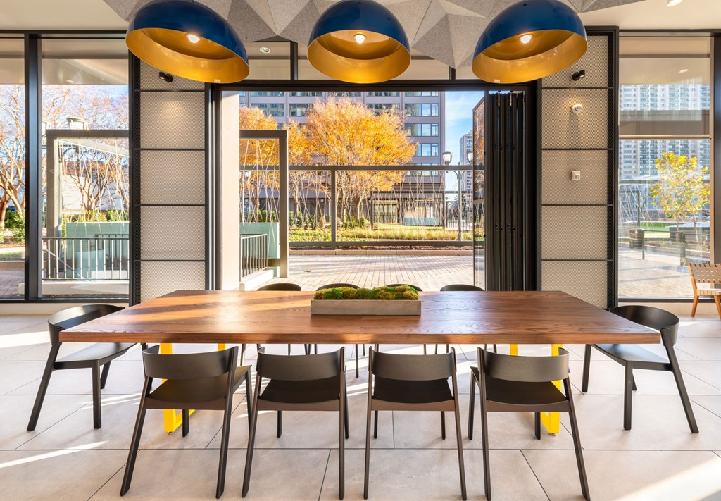 a dining room with a table and chairs in front of a window