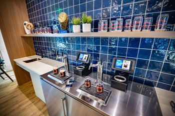 a kitchen with a counter with coffee machines and a tv