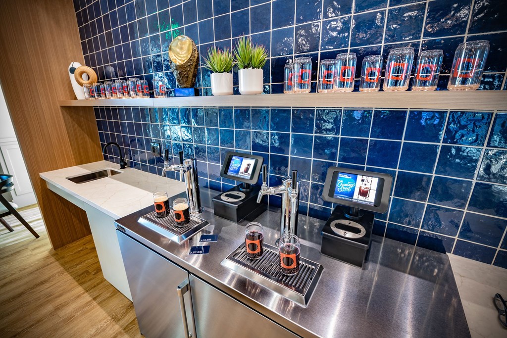 a kitchen with a counter with coffee machines and a tv