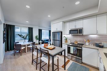 a kitchen and dining room with a table and chairs
