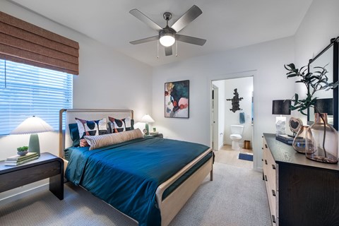 a bedroom with a bed and a ceiling fan