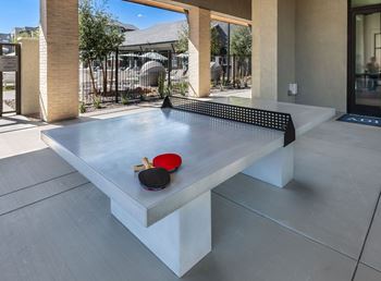 a ping pong table in the middle of a patio