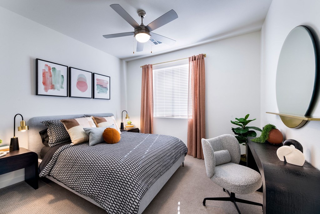 a bedroom with a bed and a ceiling fan