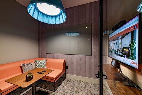 a room with a couch and a table and a television