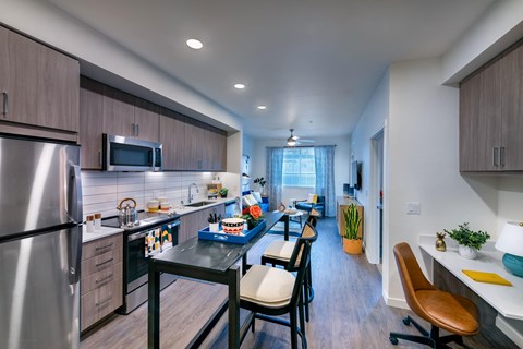 private kitchen with island and stainless steel appliances at the reserve at walnut creek apartments