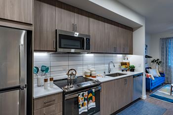 an apartment kitchen with stainless steel appliances and a sink
