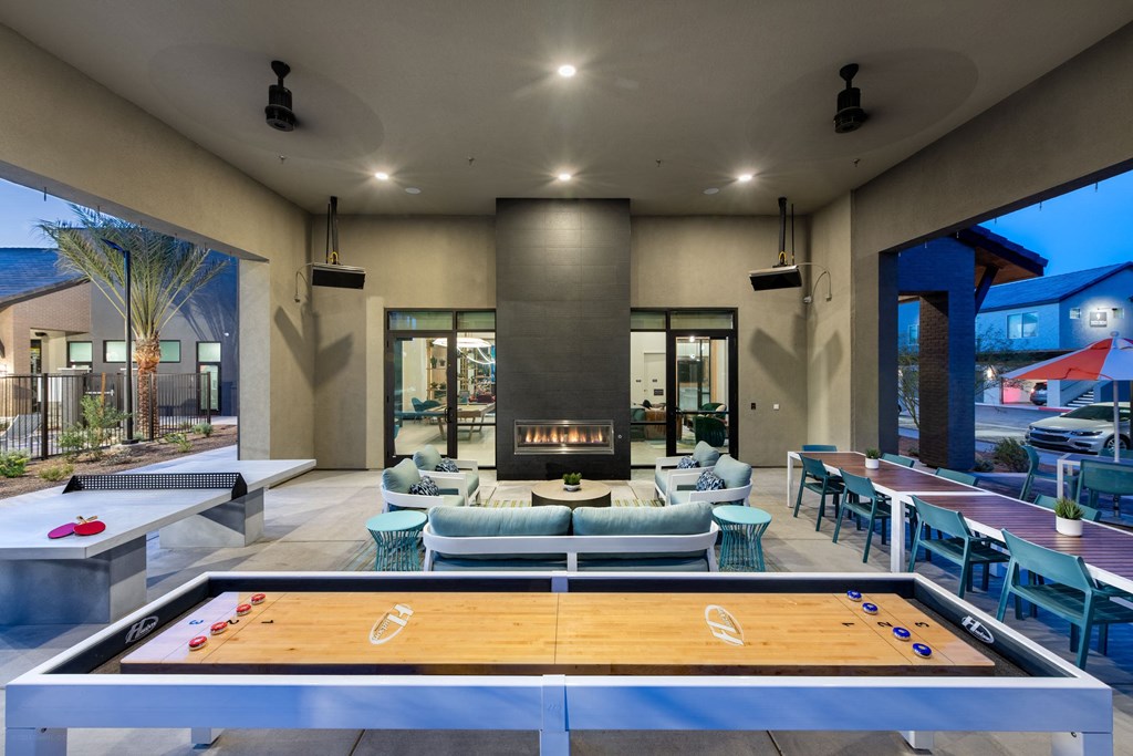 a clubhouse with a pool table and chairs and a fireplace